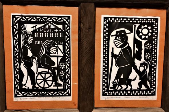 Scherenschnitte dokumentieren die aktuelle Zeit