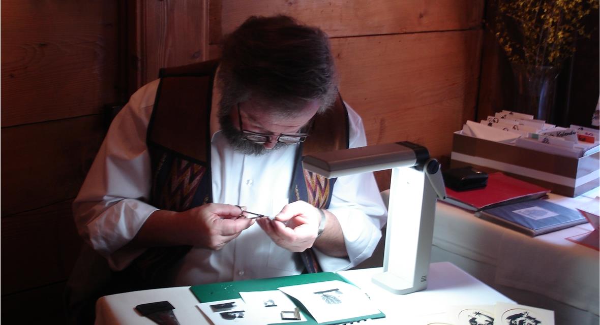 Der Künstler bei der Fertigung der kleinen Scherenschnitte.