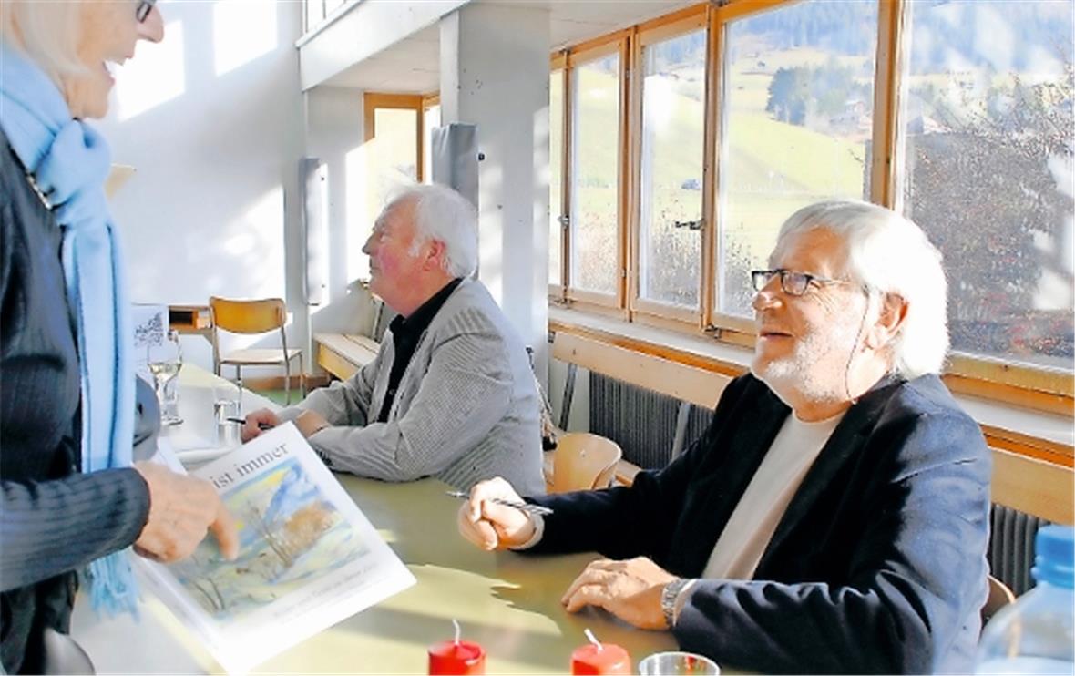 Die beiden Autoren Christian Bärtschi (vorne) und Sigi Amstutz (hinten) signieren ihre Bücher.