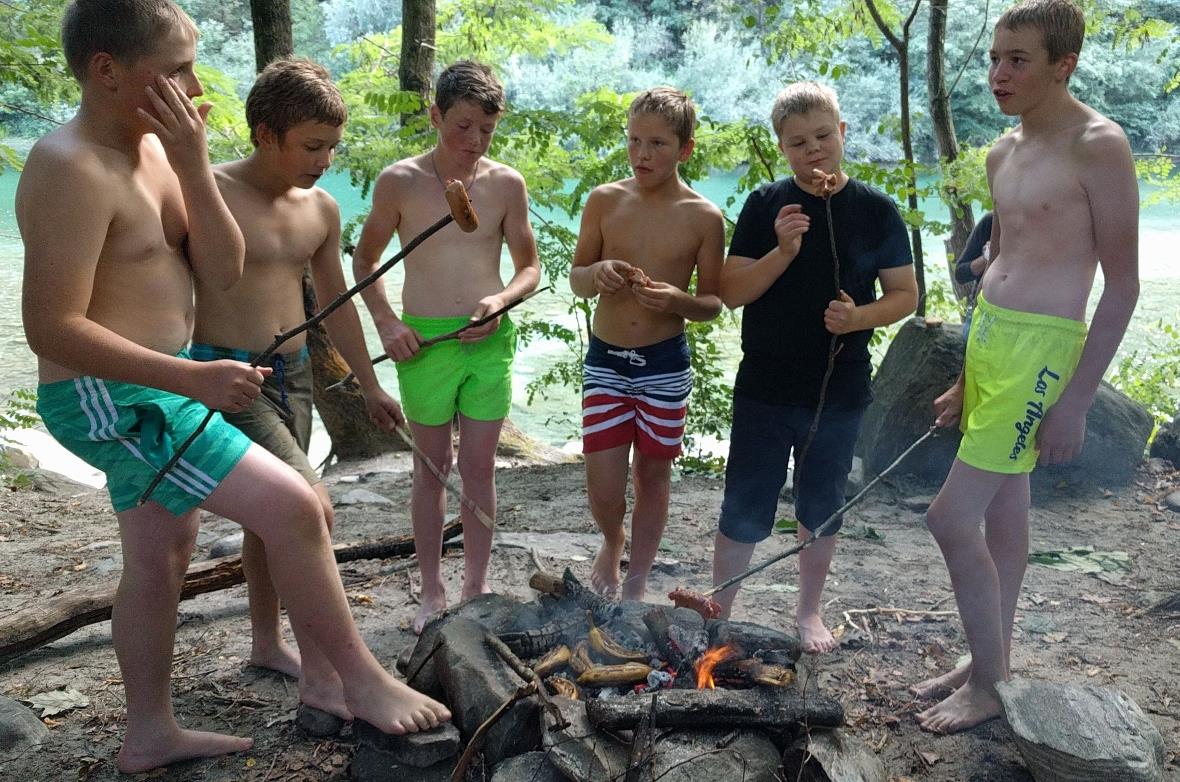 Nach dem erfrischenden Bad geniessen die Jungs ihre Cervelat.