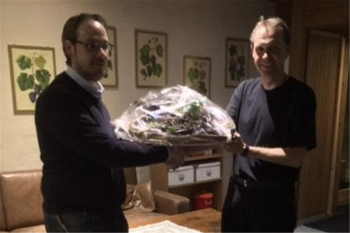 Präsident Stefan Janzi überreicht ein Präsent an Dirigent Marc Mathis.