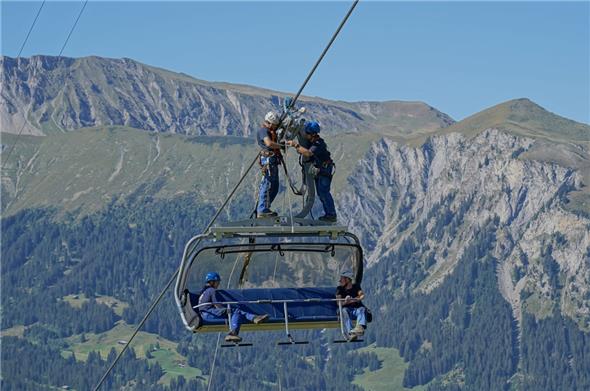 Rettung in luftiger Höhe: Um festsitzenden Gästen in einem Sessel zu helfen, müssen sich die Retter erst einmal auf das Dach begeben. Und dabei sich und ihr Material sichern.