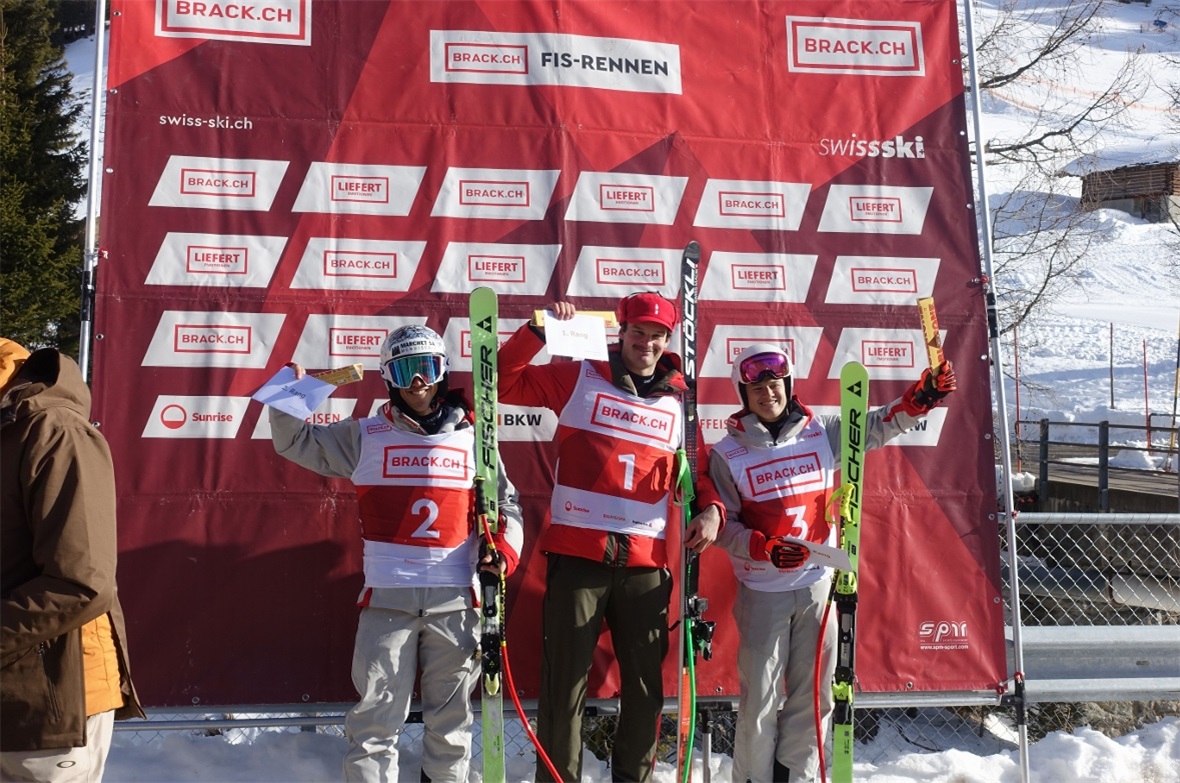 Sieger Delio Kunz aus Oey, umgeben vom Zweitplatzierten Gabin Janet aus Verbier und dem Dritten Thomas Zippert aus Arosa auf dem Podest des ersten Super-G-Rennens im Herzen des Skigebiets von Adelboden-Lenk.