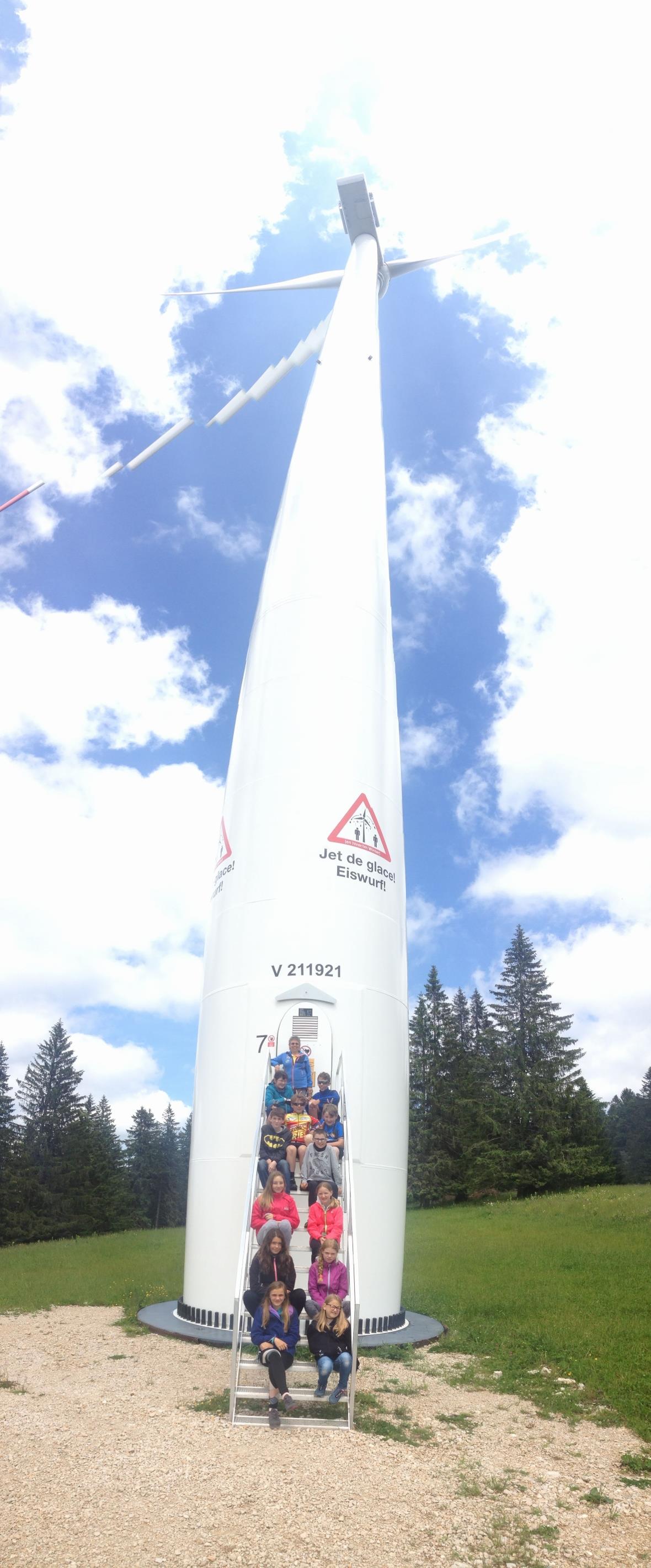 Winzig klein sind die Kinder am Fusse der grossen Windkraftanlage.